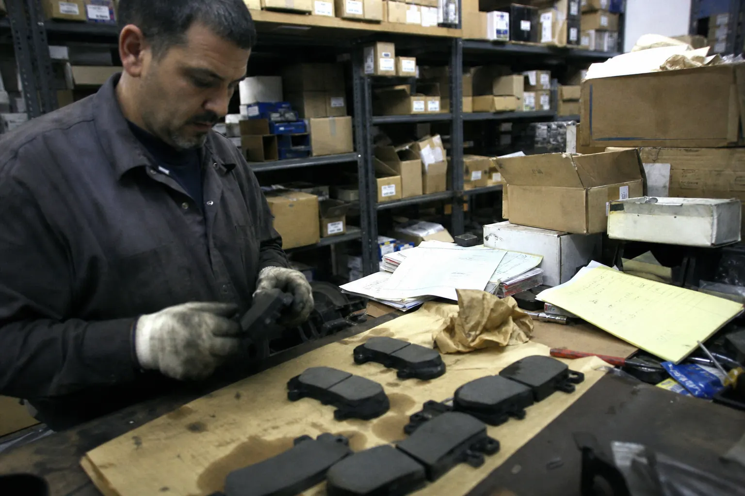 Parts buyer comparing heavy-duty brake pad references for electric vans and pickup trucks